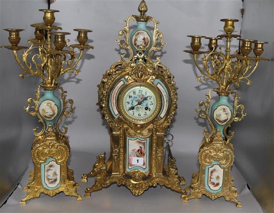 A Louis XV style 3 piece clock set flanked by 5-light candelabra